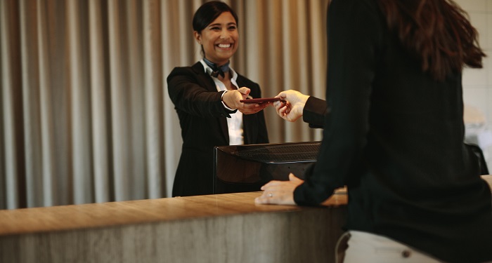 hotel employee gives guest a key card